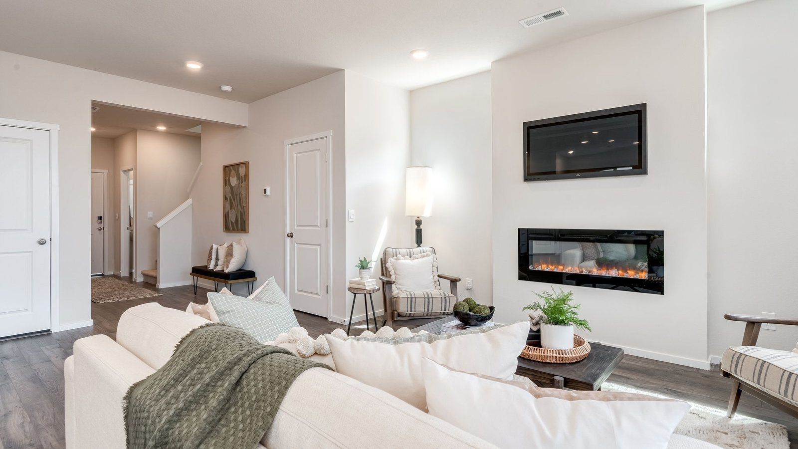 Great room with laminate flooring and an electric fireplace