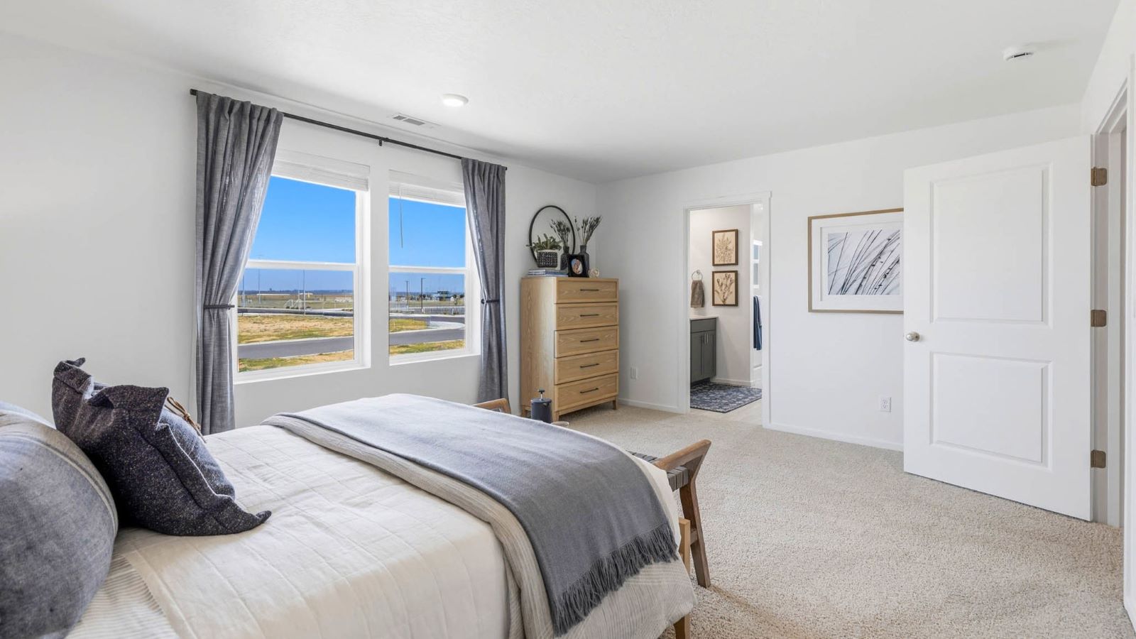 Primary bedroom with wall-to-wall carpet, a walk-in closet and an attached bathroom
