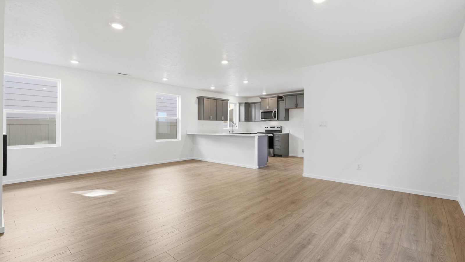 Great room with laminate flooring and an electric fireplace