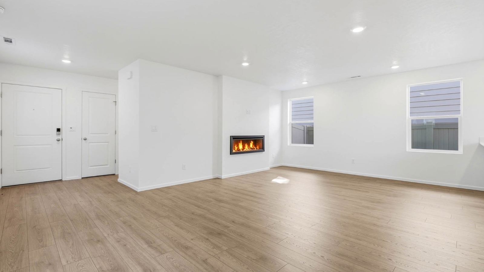 Great room with laminate flooring and an electric fireplace