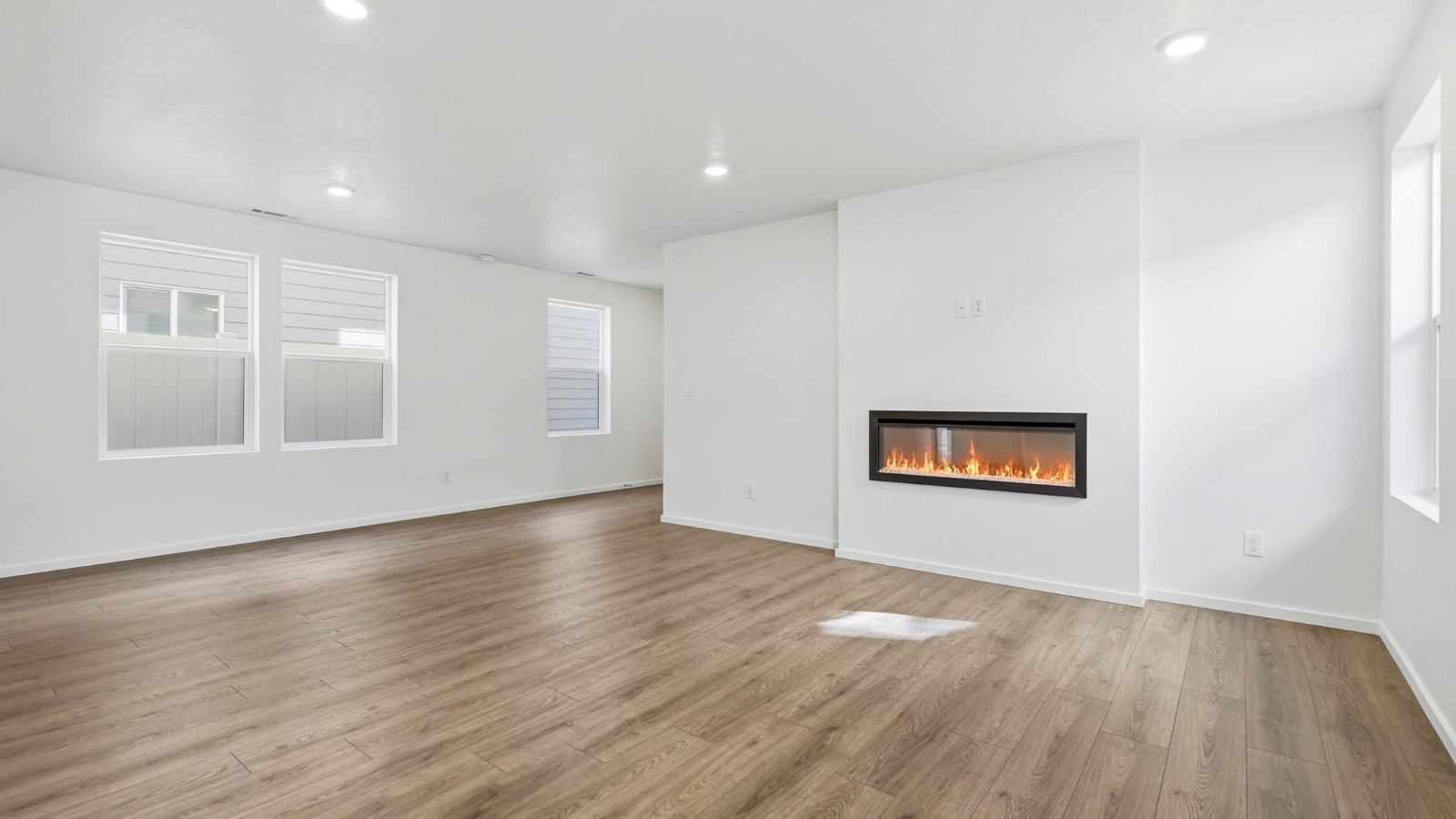 Great room with laminate flooring and an electric fireplace
