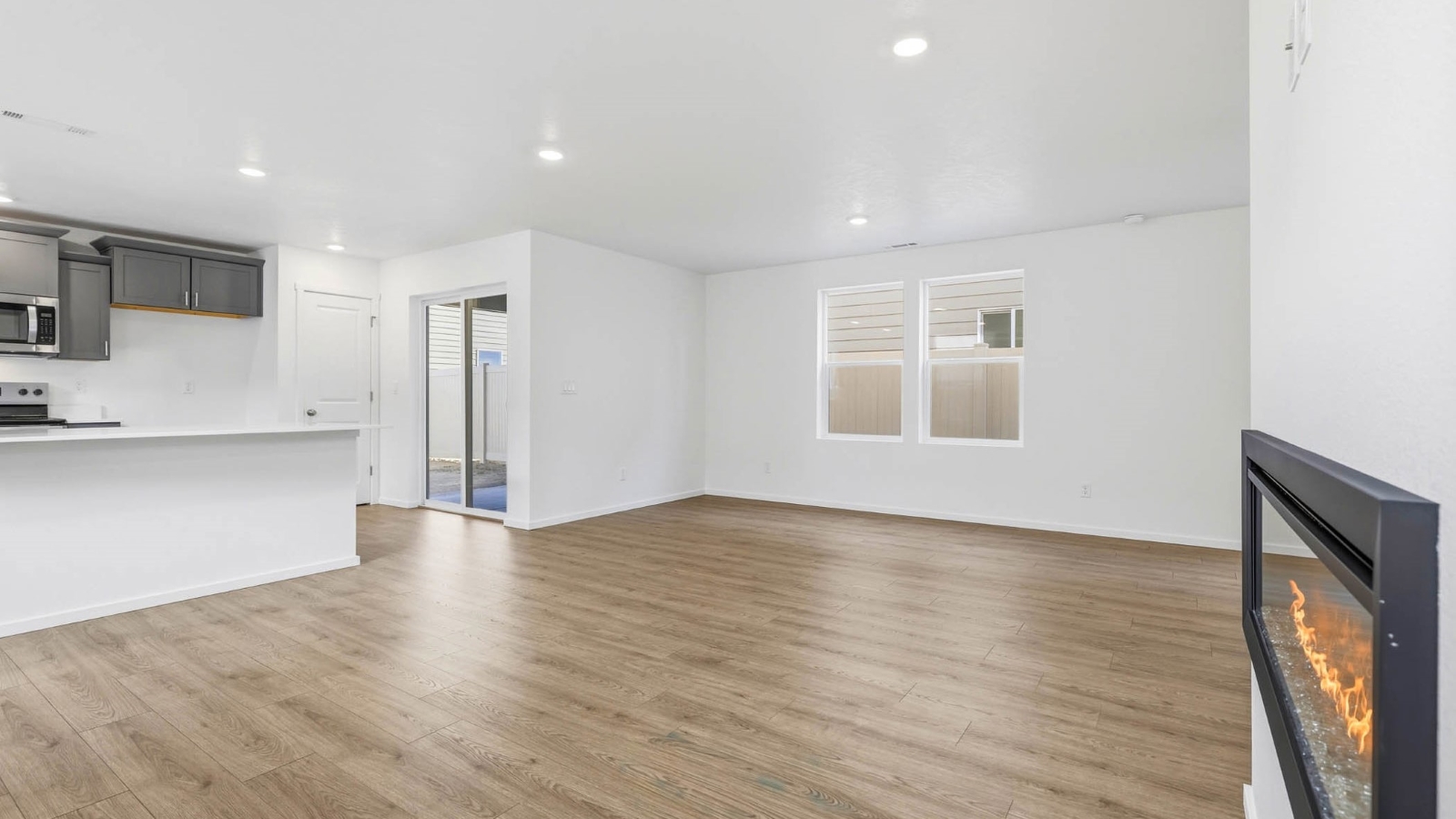 Great room with laminate flooring and an electric fireplace