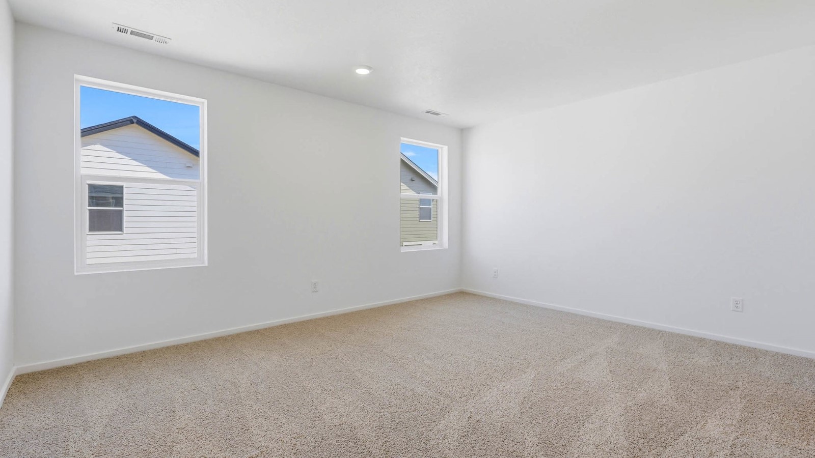 Primary bedroom with wall-to-wall carpet, a walk-in closet and an attached bathroom
