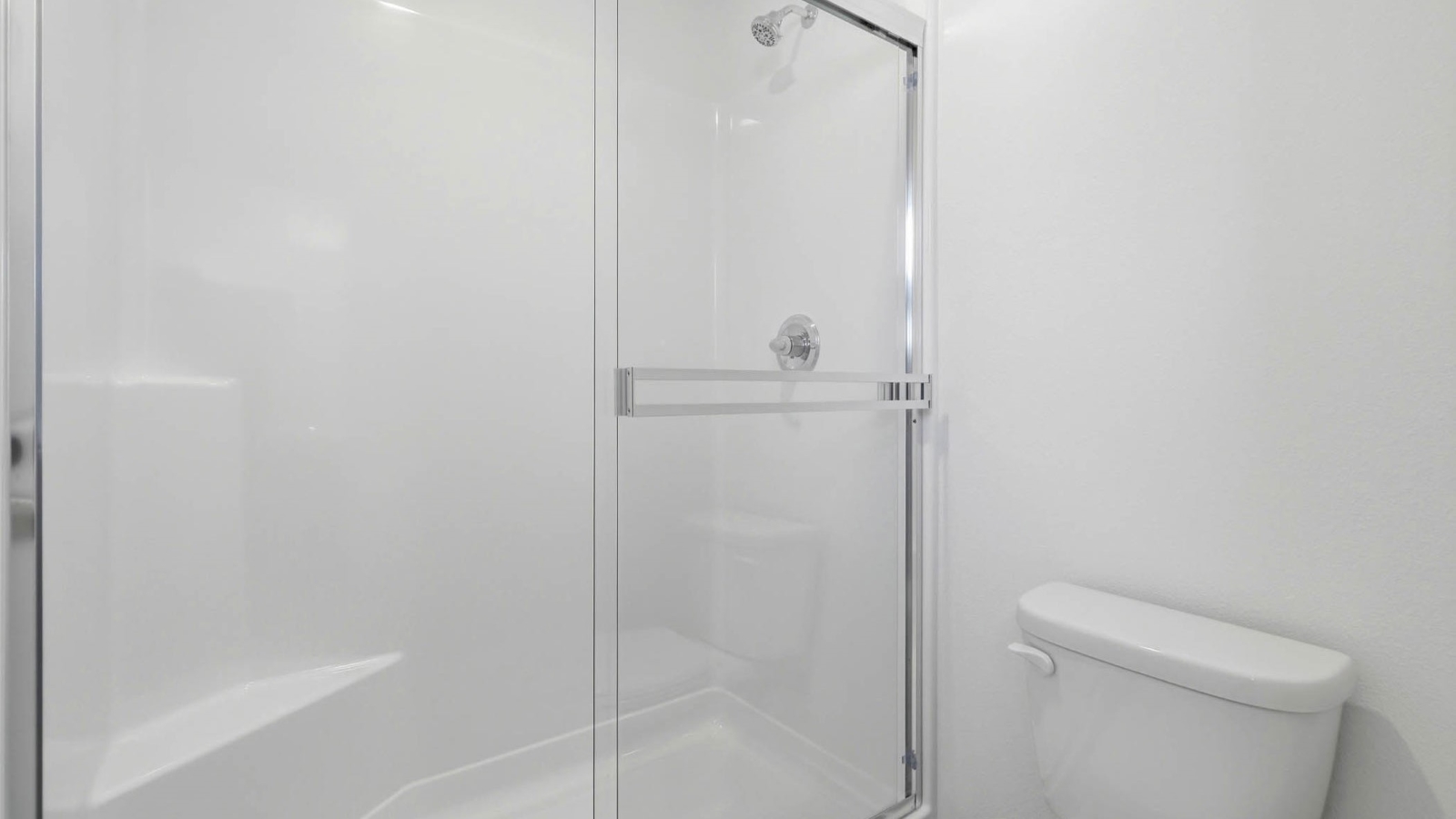 Primary bathroom with quartz counters and a walk-in shower