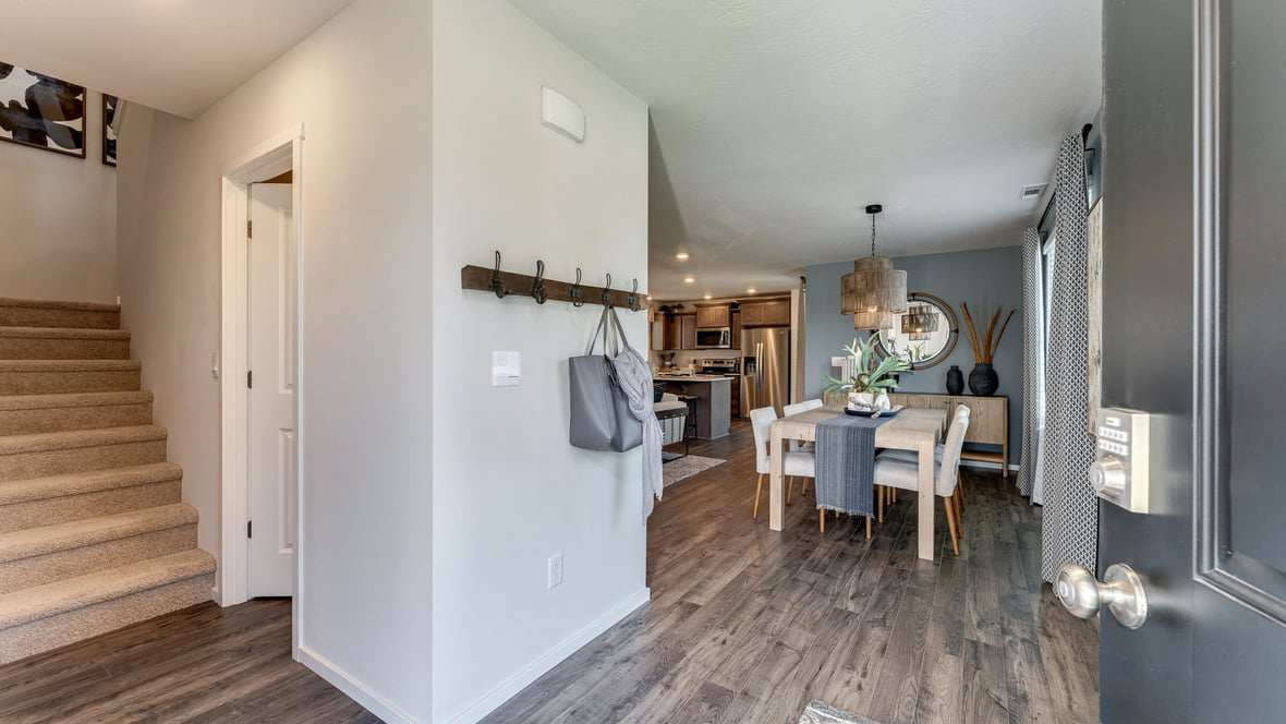 Entryway with a coat closet and laminate flooring