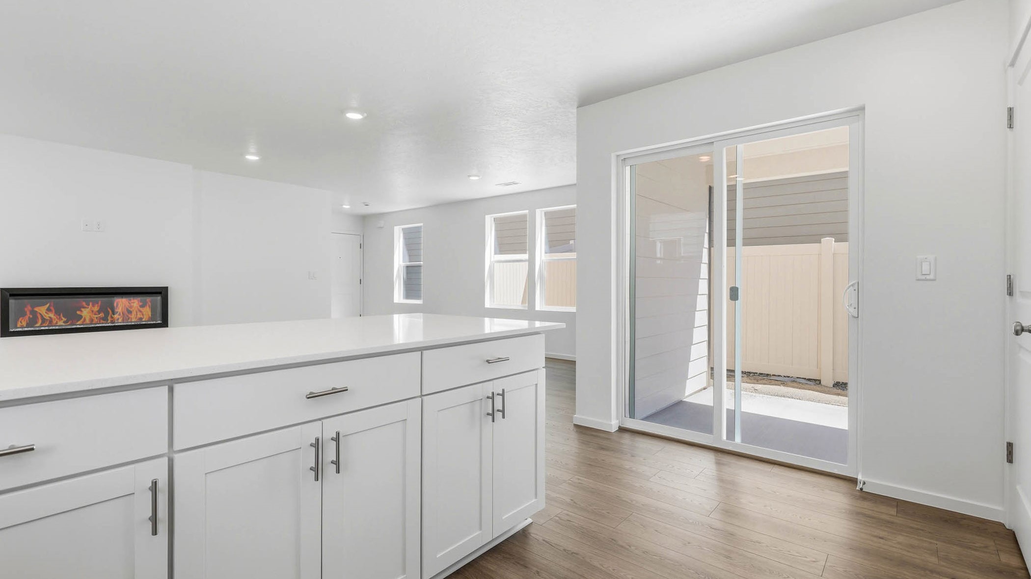 U-shaped kitchen with shaker cabinets, quartz counters, stainless steel appliances, pantry, and a breakfast bar