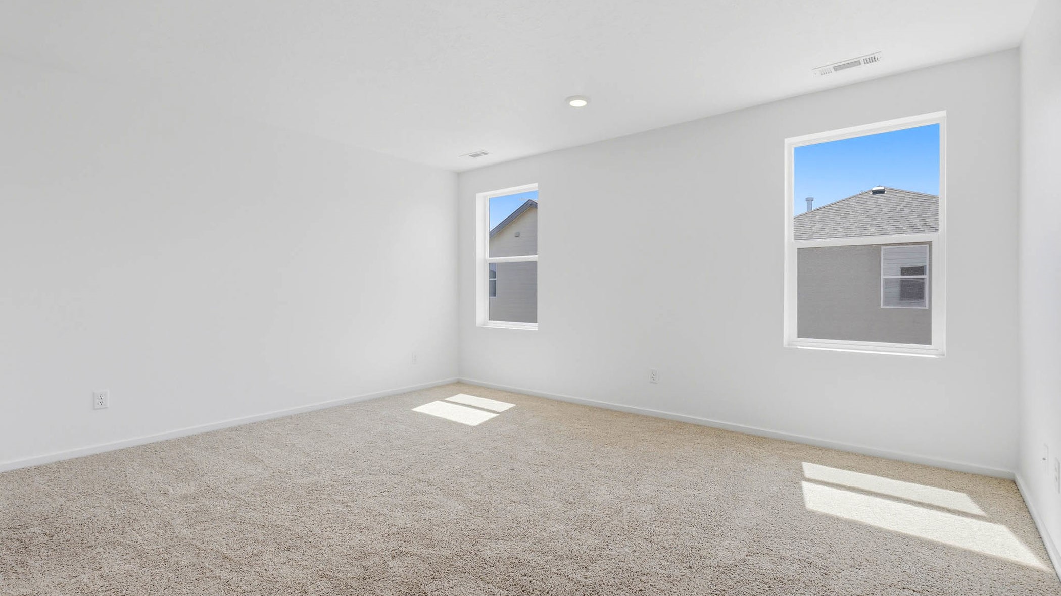 Primary bedroom with wall-to-wall carpet, a walk-in closet and an attached bathroom
