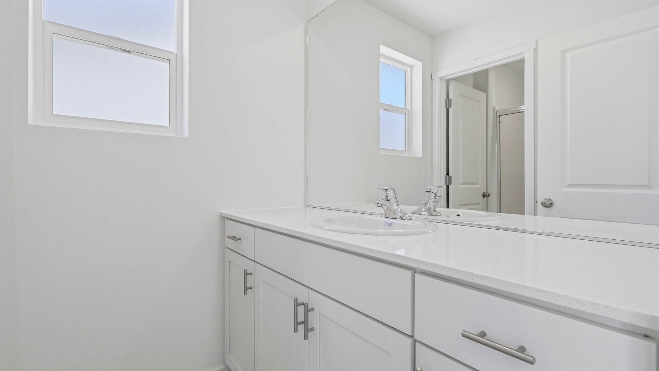 Primary bathroom with quartz counters and a walk-in shower