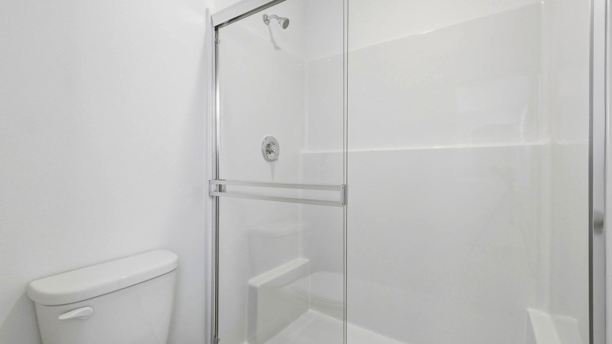 Primary bathroom with quartz counters and a walk-in shower