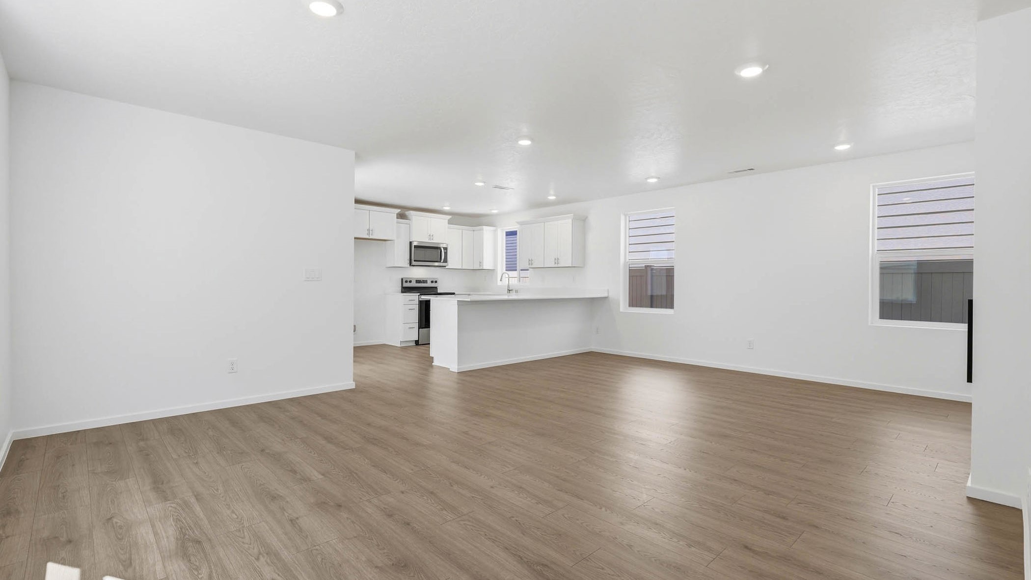 Great room with laminate flooring and an electric fireplace