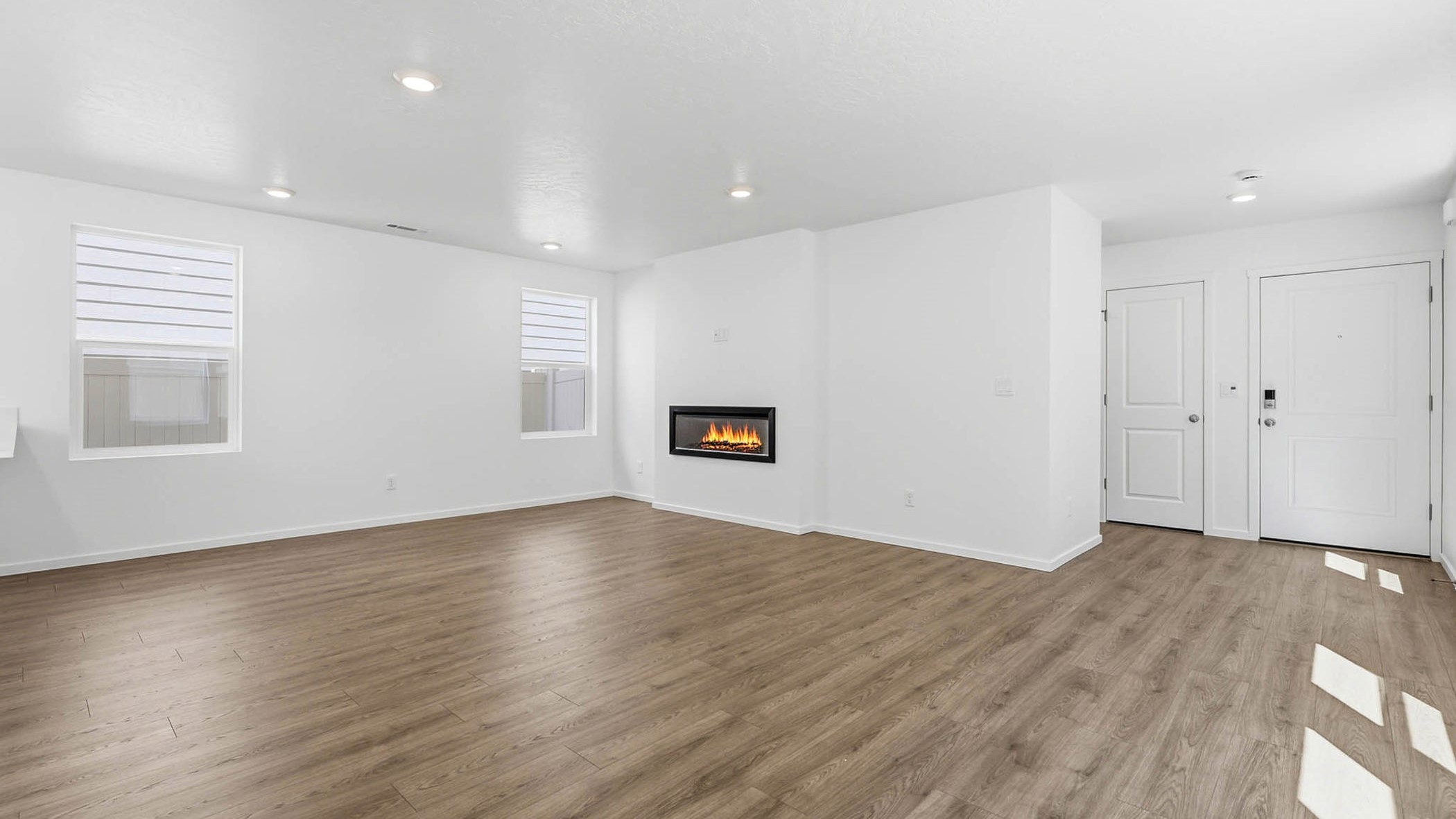 Great room with laminate flooring and an electric fireplace
