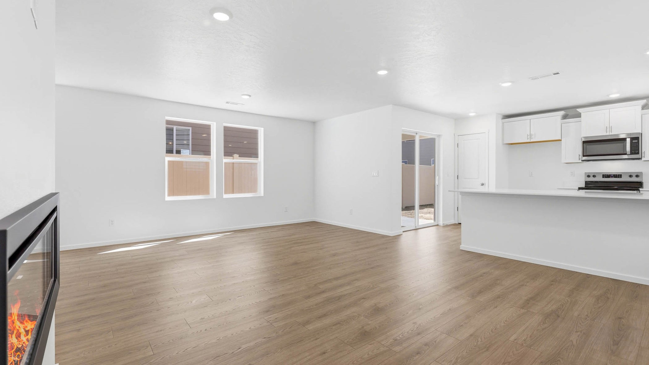 Great room with laminate flooring and an electric fireplace