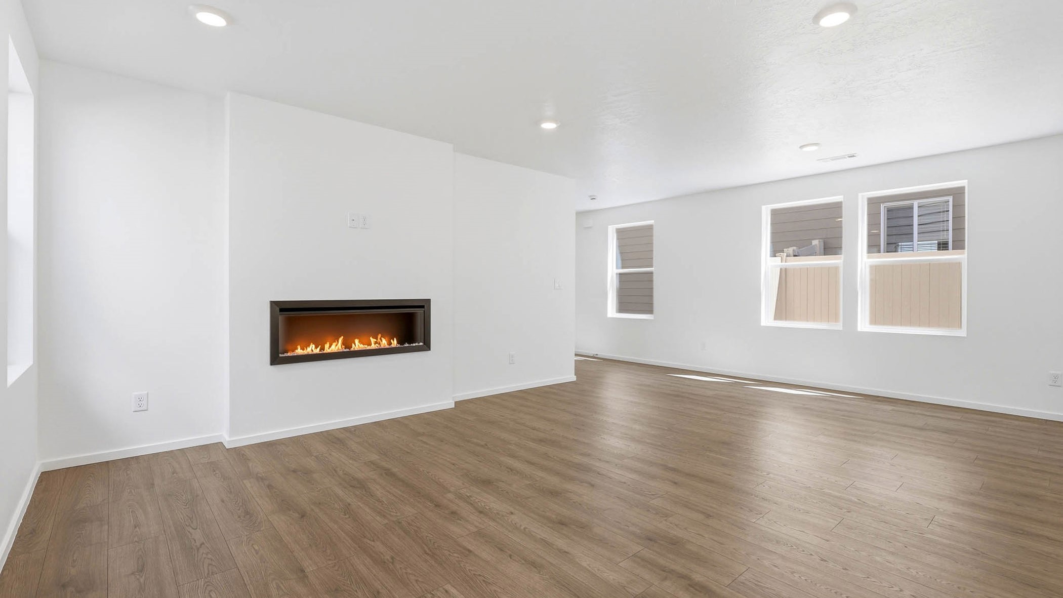Great room with laminate flooring and an electric fireplace