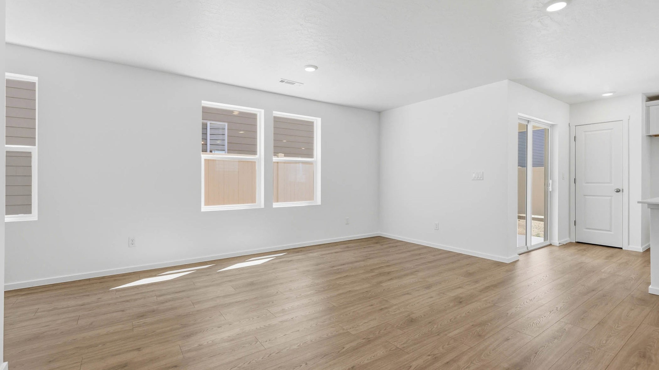 Great room with laminate flooring and an electric fireplace
