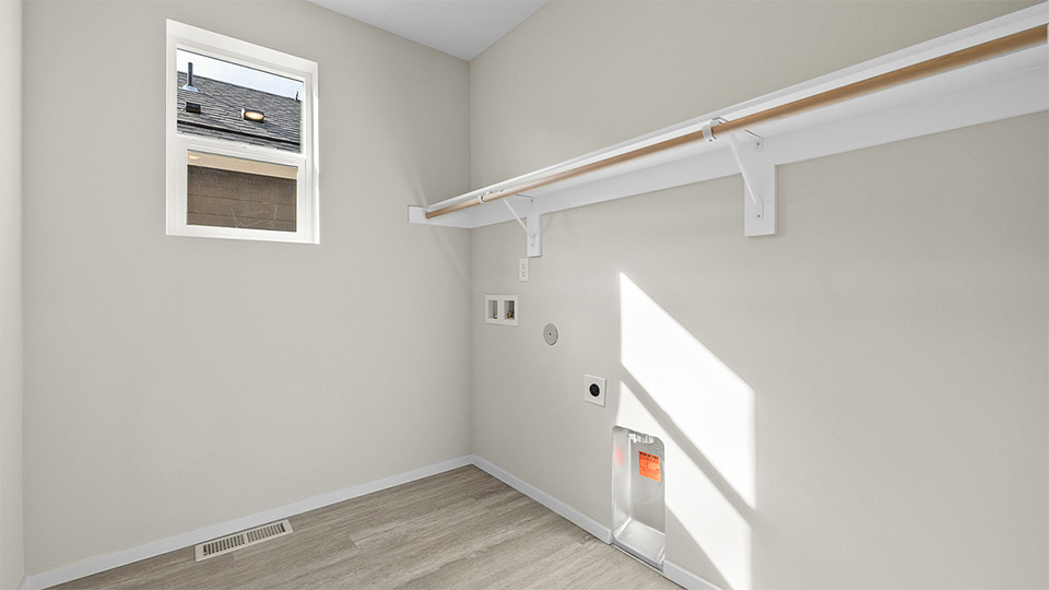 Laundry room with built-in shelves and washer and dryer hookups
