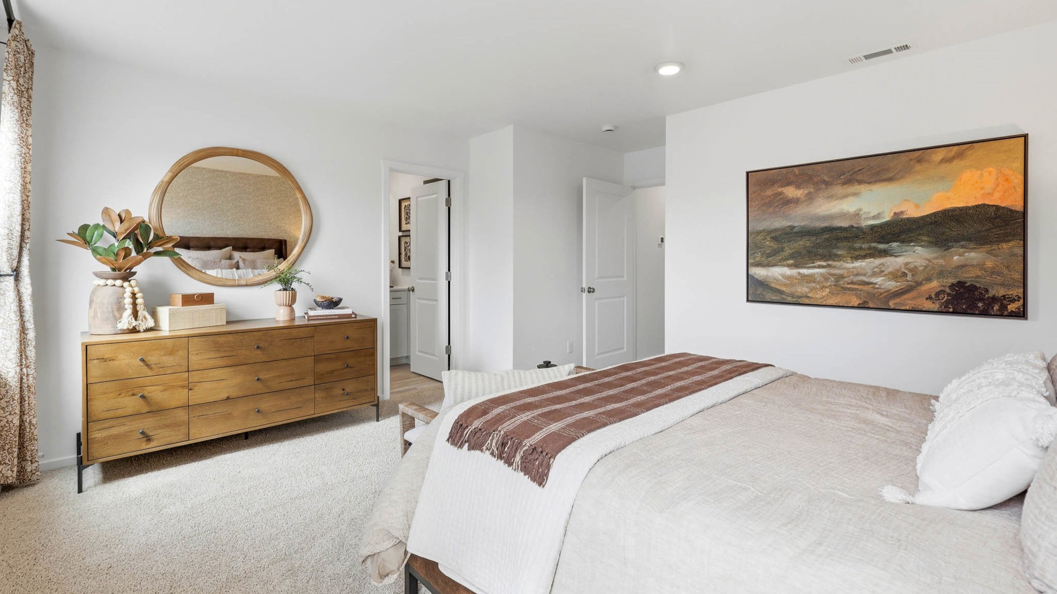 Primary bedroom with wall-to-wall carpet, a walk-in closet and an attached bathroom