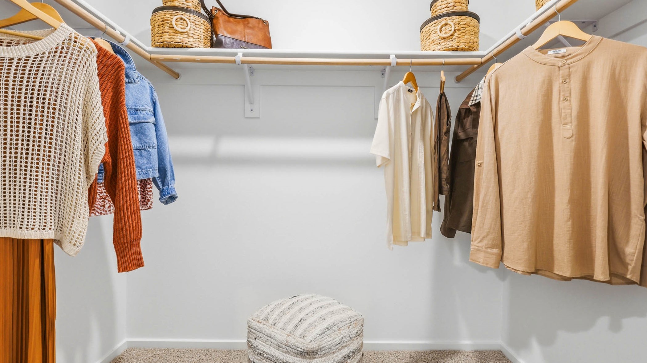 Primary bedroom walk-in closet with built-in shelves