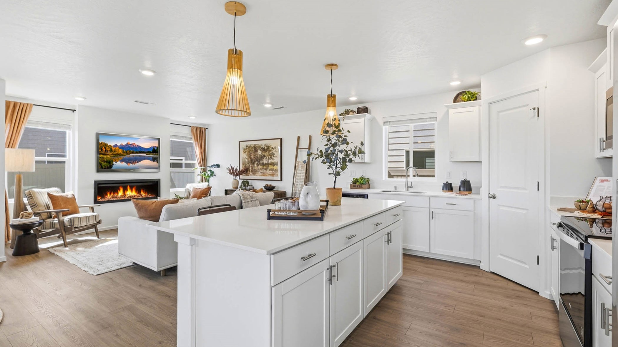 Kitchen with shaker cabinets, quartz counters, stainless steel appliances, pantry, and an island with a breakfast bar