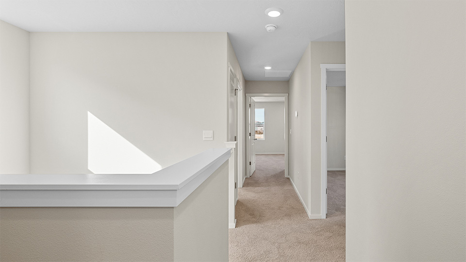 Hallway with wall-to-wall carpet
