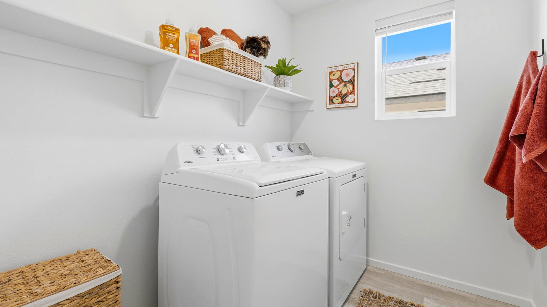 Laundry room with built-in shelves and washer and dryer hookups