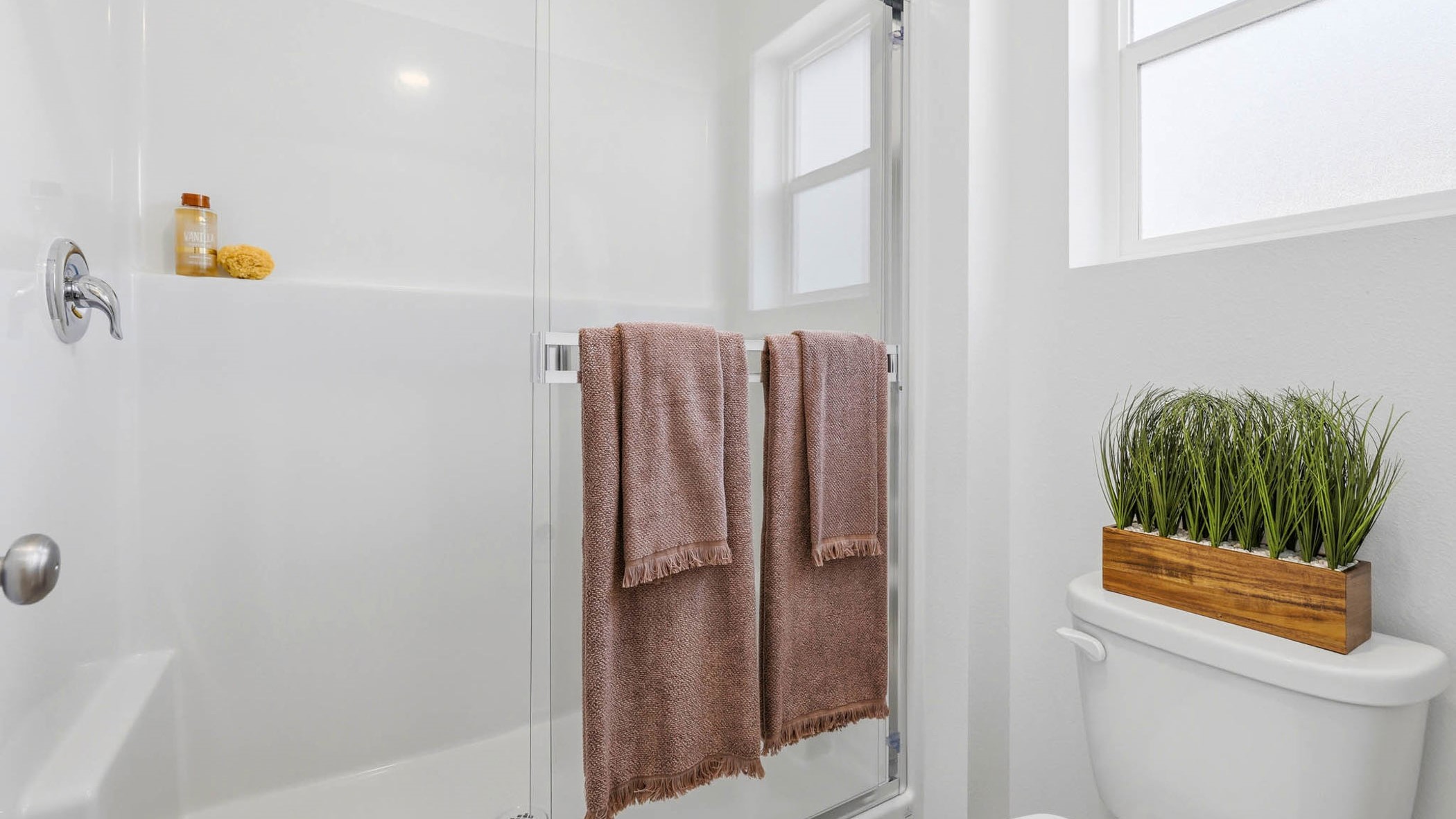Primary bathroom with quartz counters and a walk-in shower