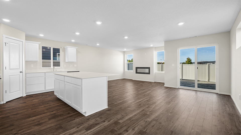 Kitchen with shaker cabinets, quartz counters, stainless steel appliances, pantry, and an island with a breakfast bar