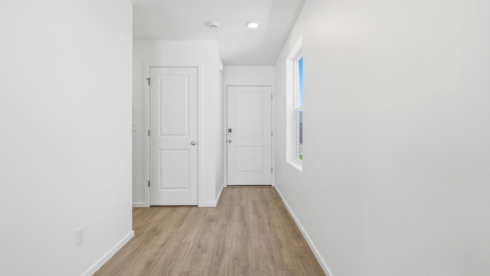 Entryway with a coat closet and laminate flooring