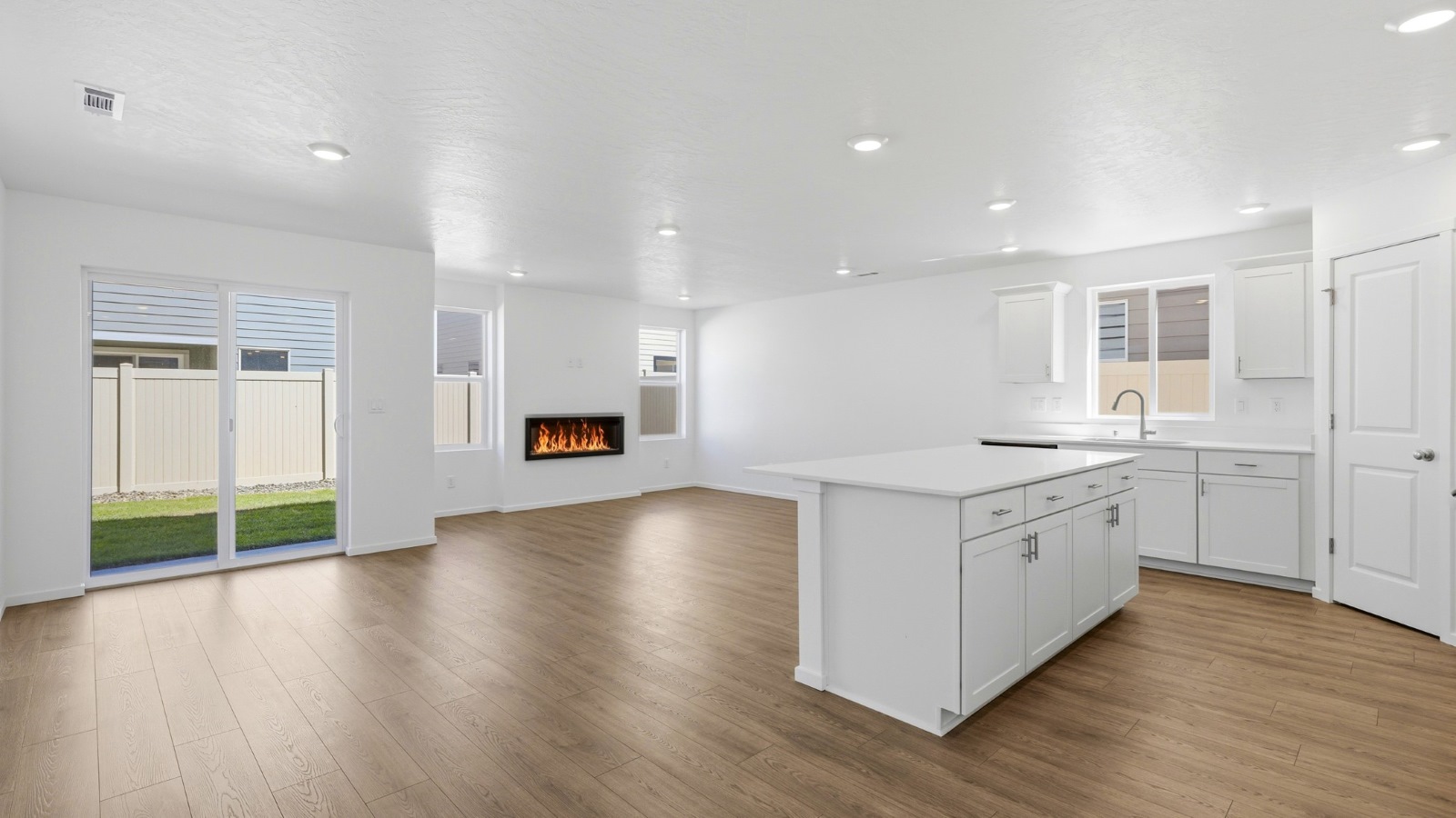Kitchen with shaker cabinets, quartz counters, stainless steel appliances, pantry, and an island with a breakfast bar