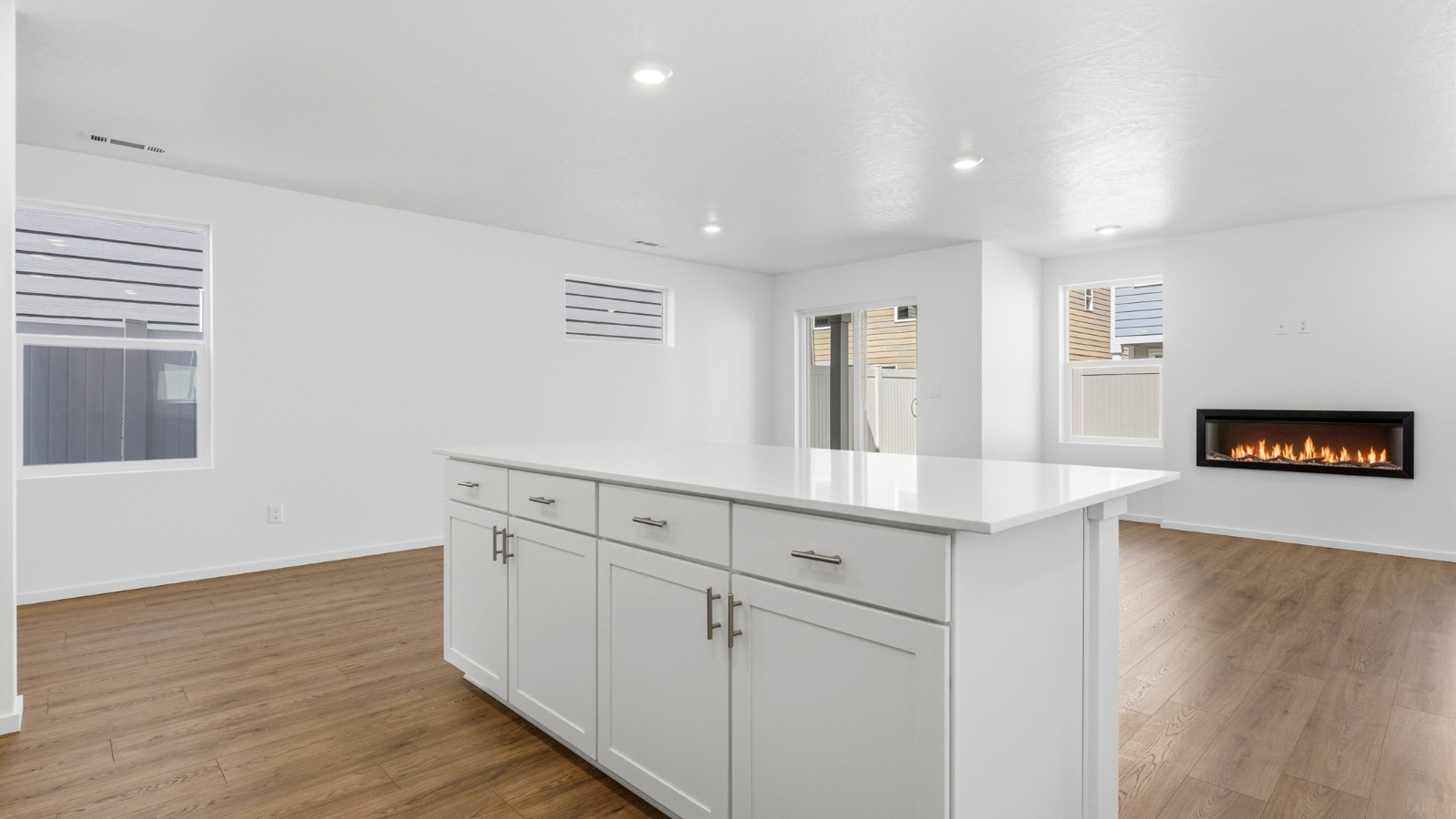 Kitchen with shaker cabinets, quartz counters, stainless steel appliances, pantry, and an island with a breakfast bar