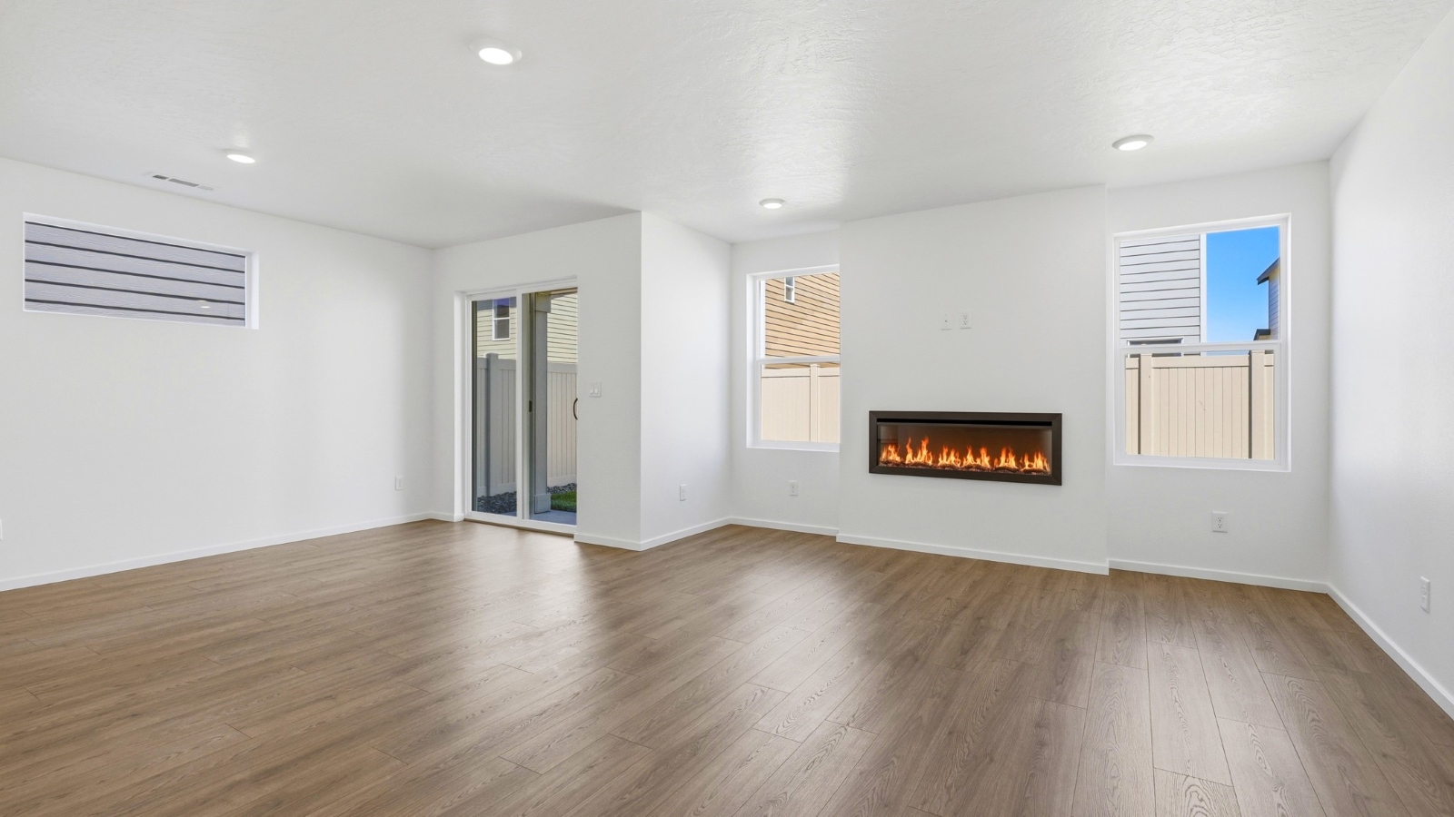 Great room with laminate flooring and an electric fireplace