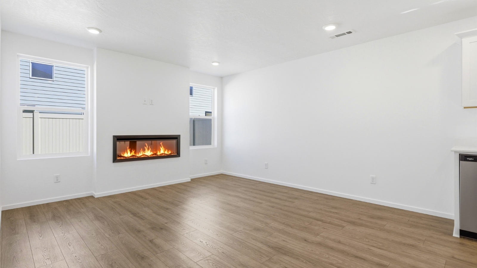 Great room with laminate flooring and an electric fireplace