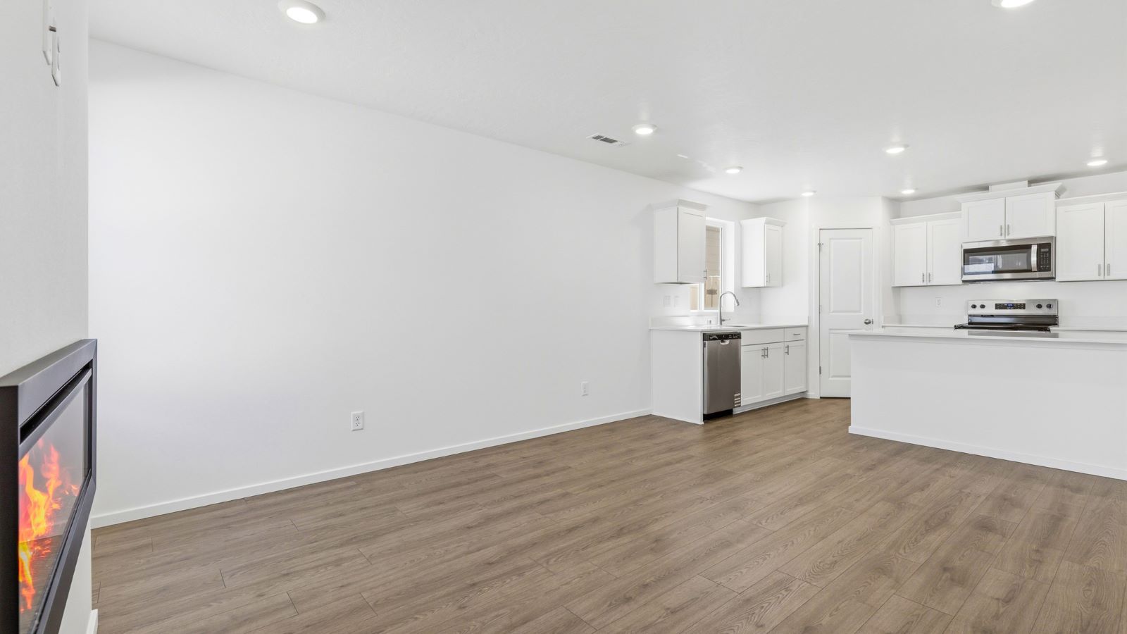 Great room with laminate flooring and an electric fireplace