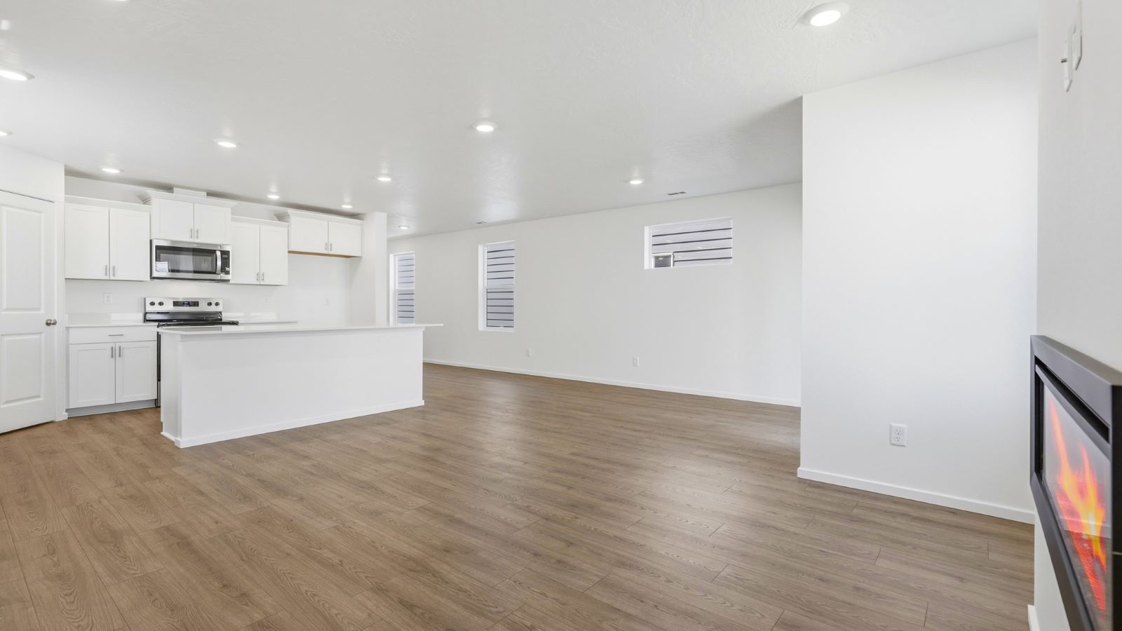 Great room with laminate flooring and an electric fireplace