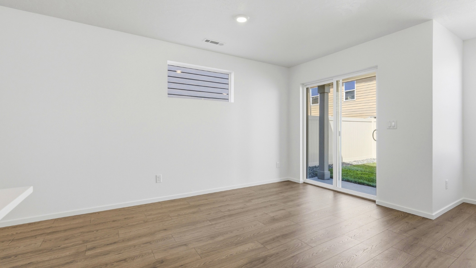 Dining area with a sliding glass door to a fenced backyard