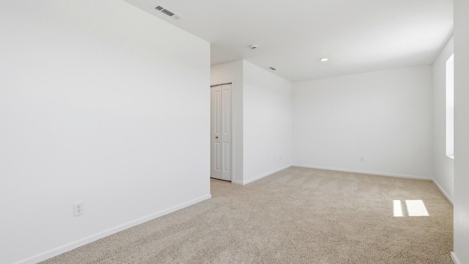 Bedroom with wall-to-wall carpet and a closet