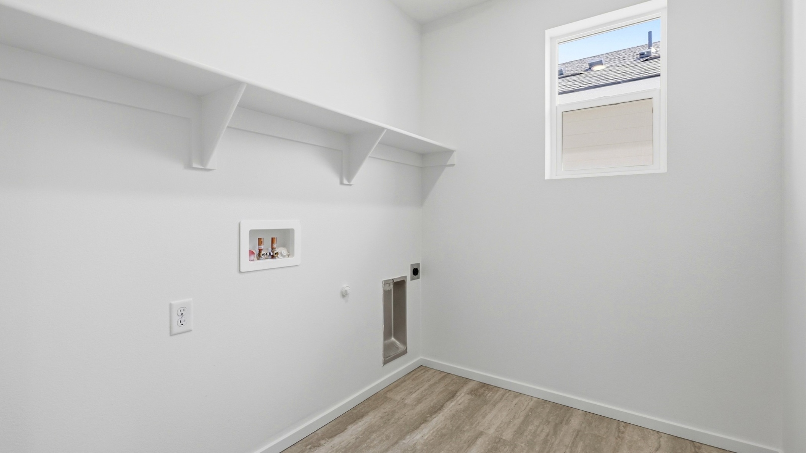 Laundry room with built-in shelves and washer and dryer hookups