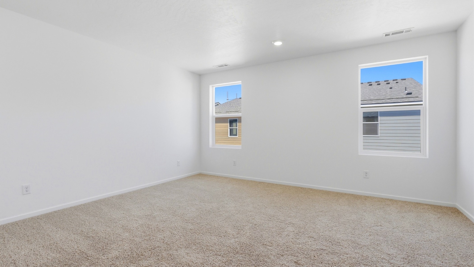 Primary bedroom with wall-to-wall carpet, a walk-in closet and an attached bathroom