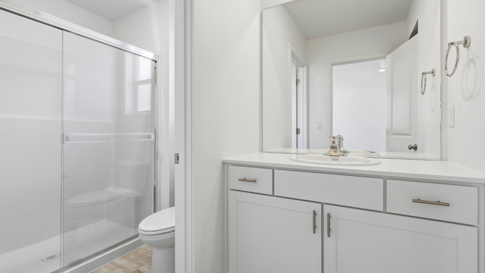 Primary bathroom with quartz counters and a walk-in shower