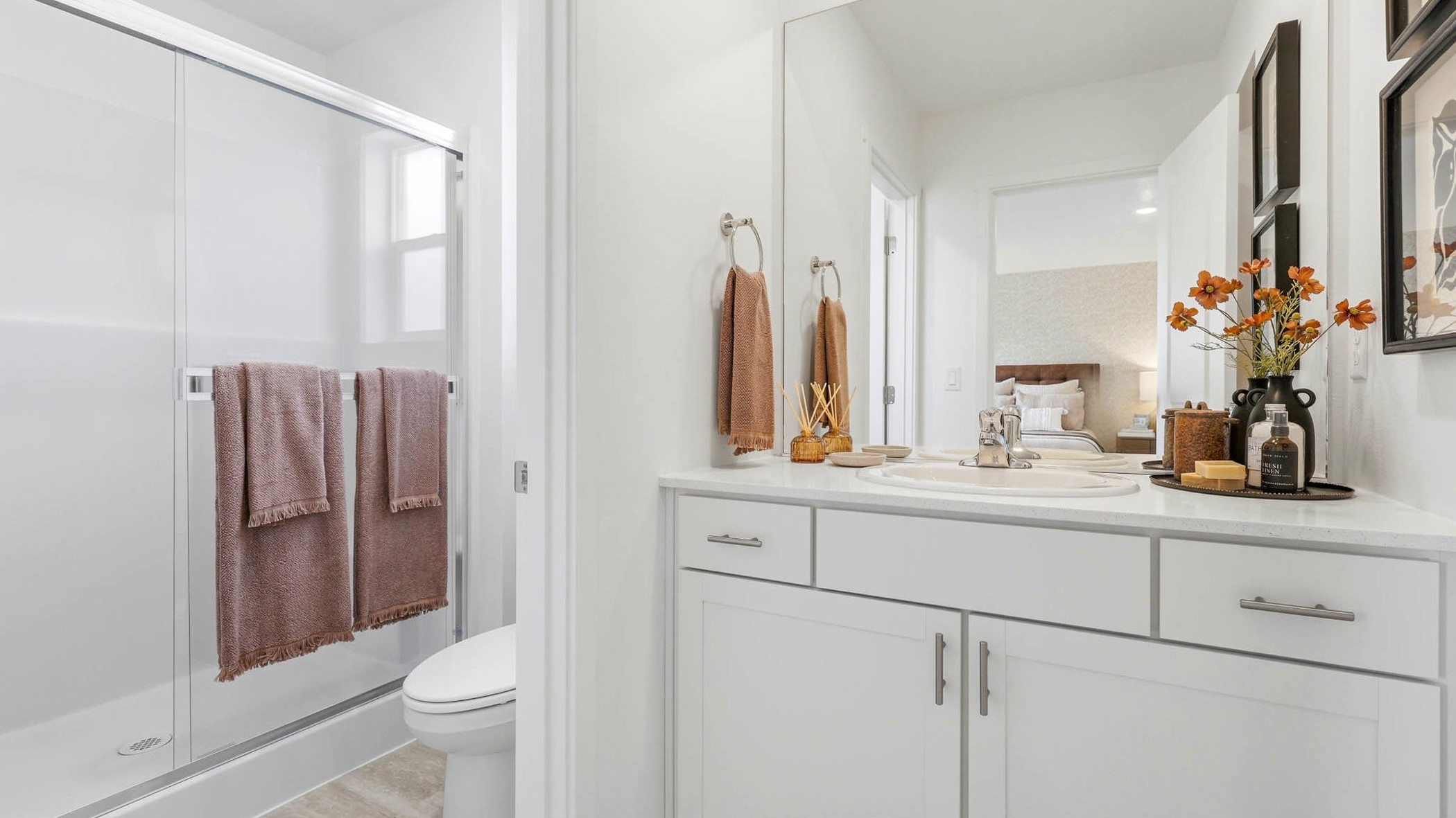 Primary bathroom with quartz counters and a walk-in shower