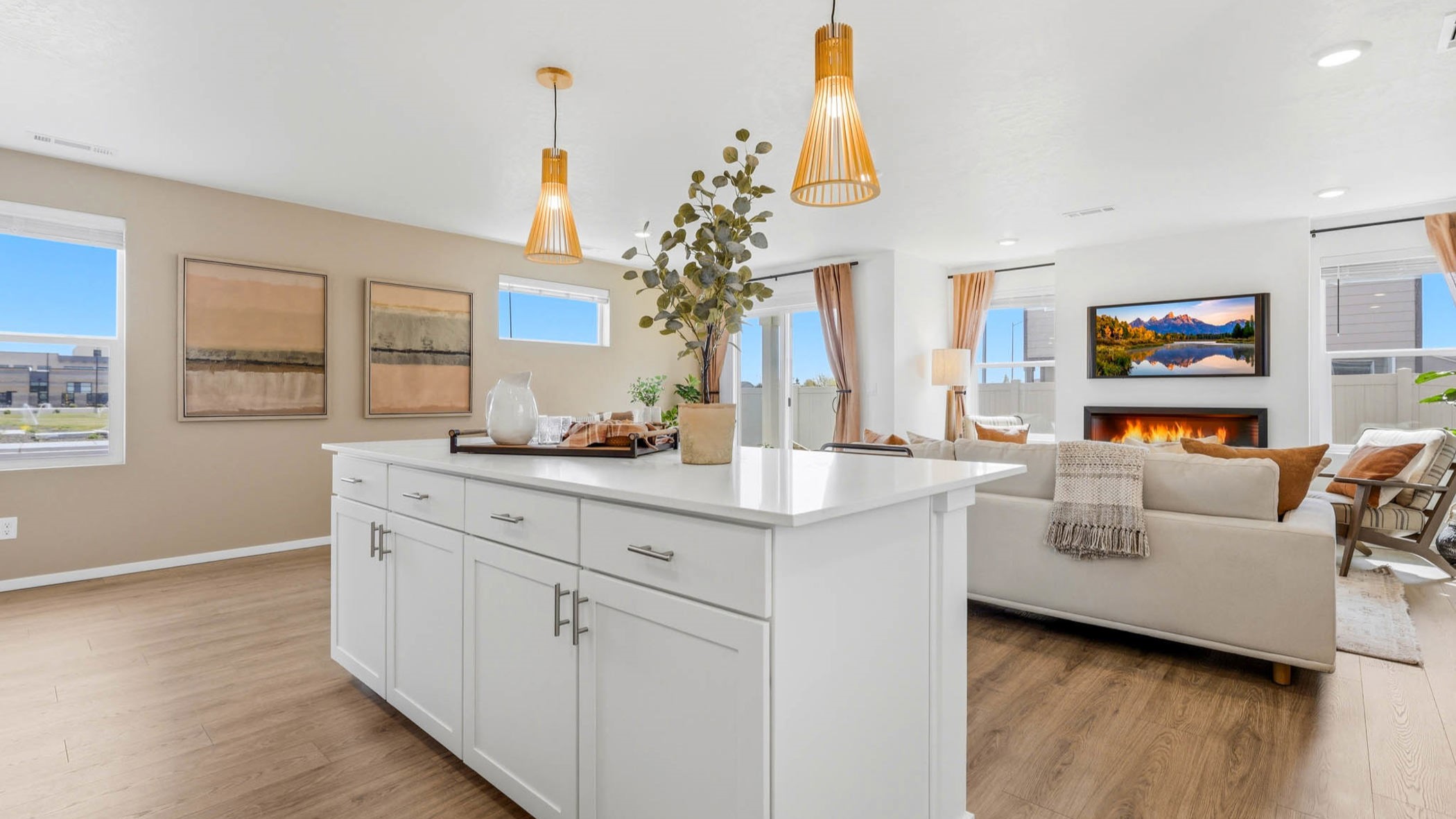 Kitchen with shaker cabinets, quartz counters, stainless steel appliances, pantry, and an island with a breakfast bar
