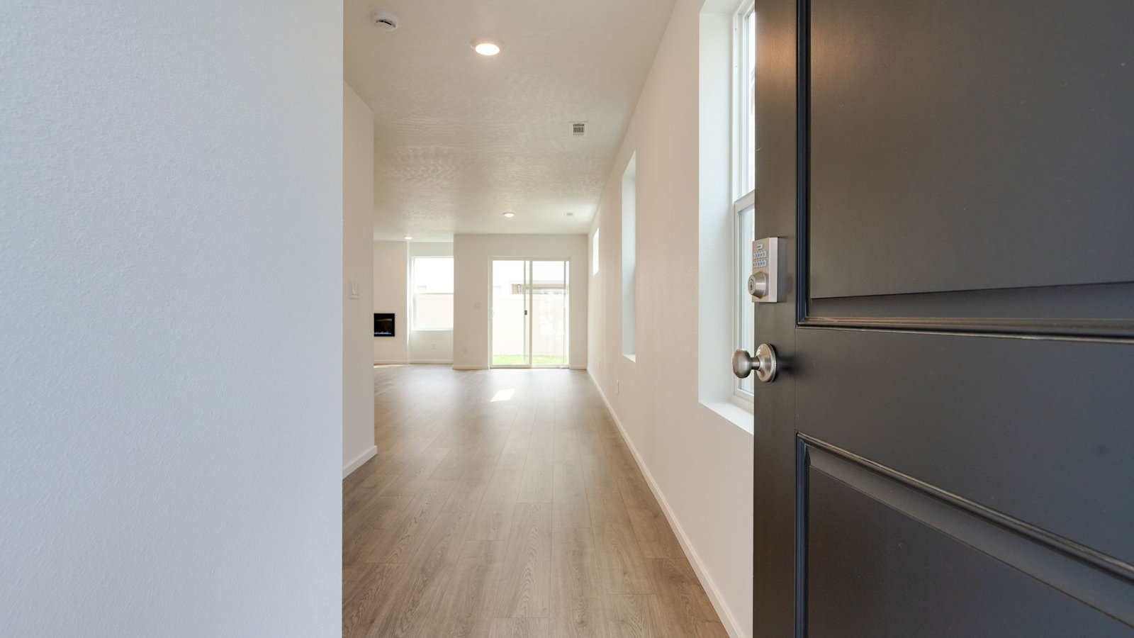Entryway with a coat closet and laminate flooring