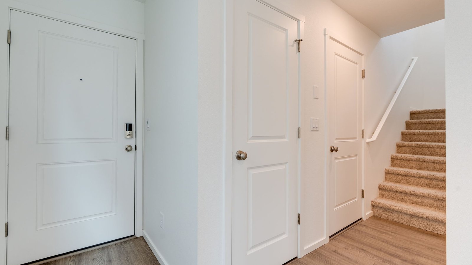 Entryway with a coat closet and laminate flooring