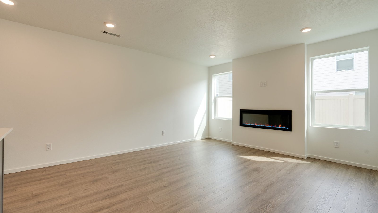 Great room with laminate flooring and an electric fireplace