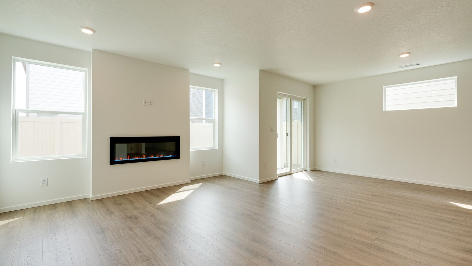 Great room with laminate flooring and an electric fireplace