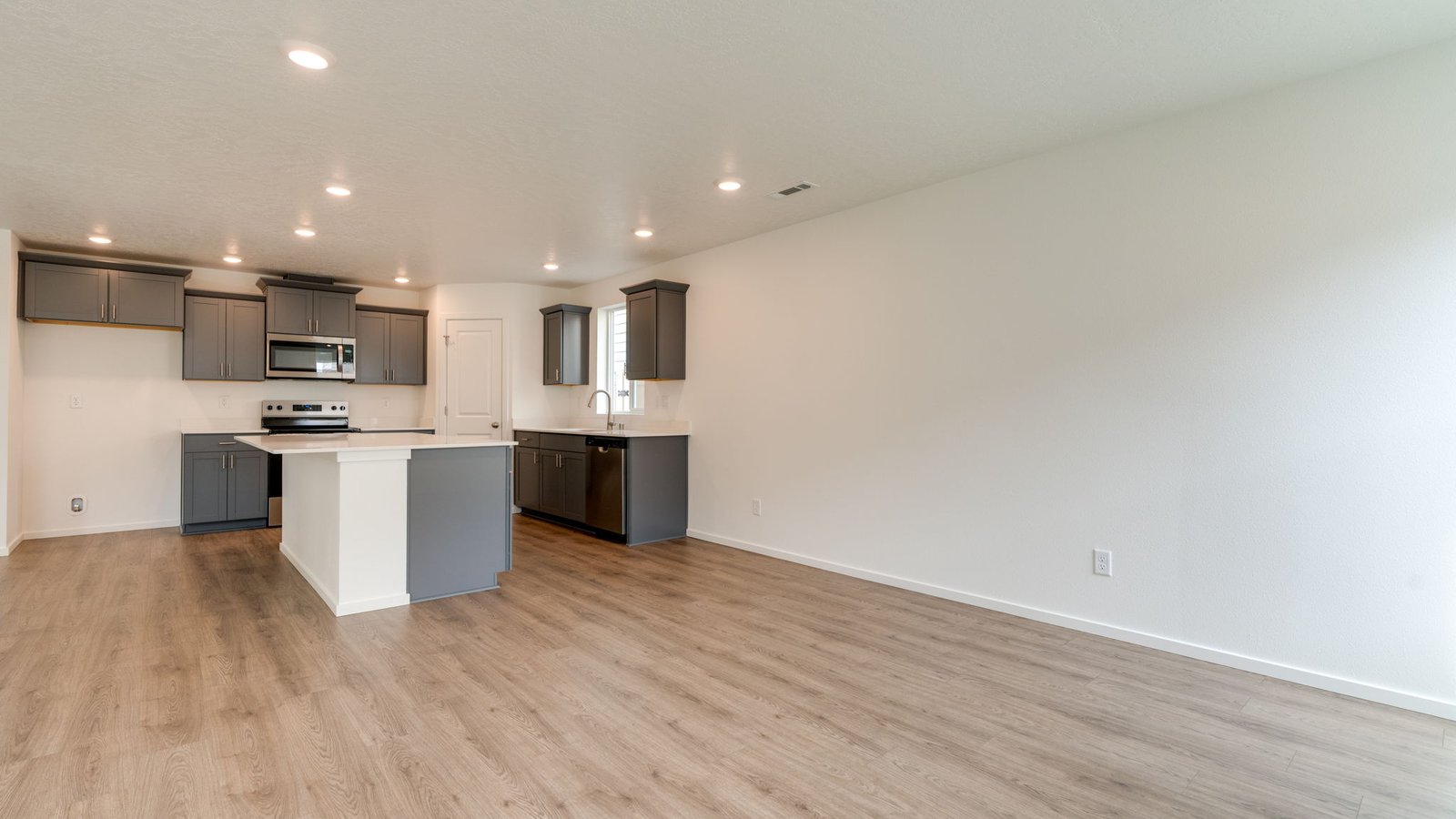 Great room with laminate flooring and an electric fireplace