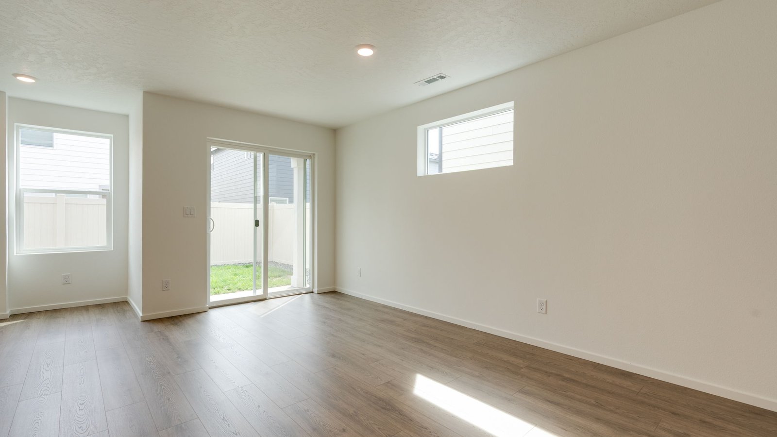 Dining area with a sliding glass door to a fenced backyard