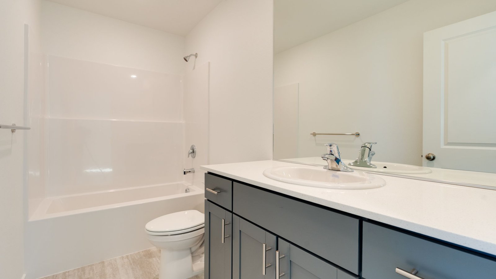 Hall bathroom with combination tub/shower and quartz counters