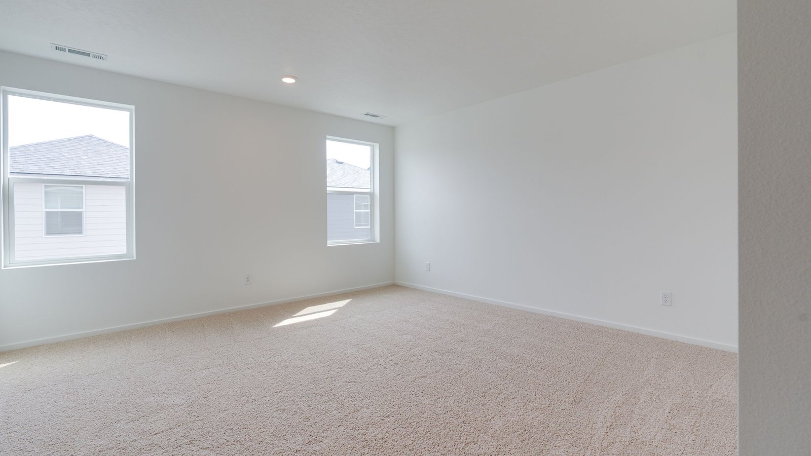 Primary bedroom with wall-to-wall carpet, a walk-in closet and an attached bathroom