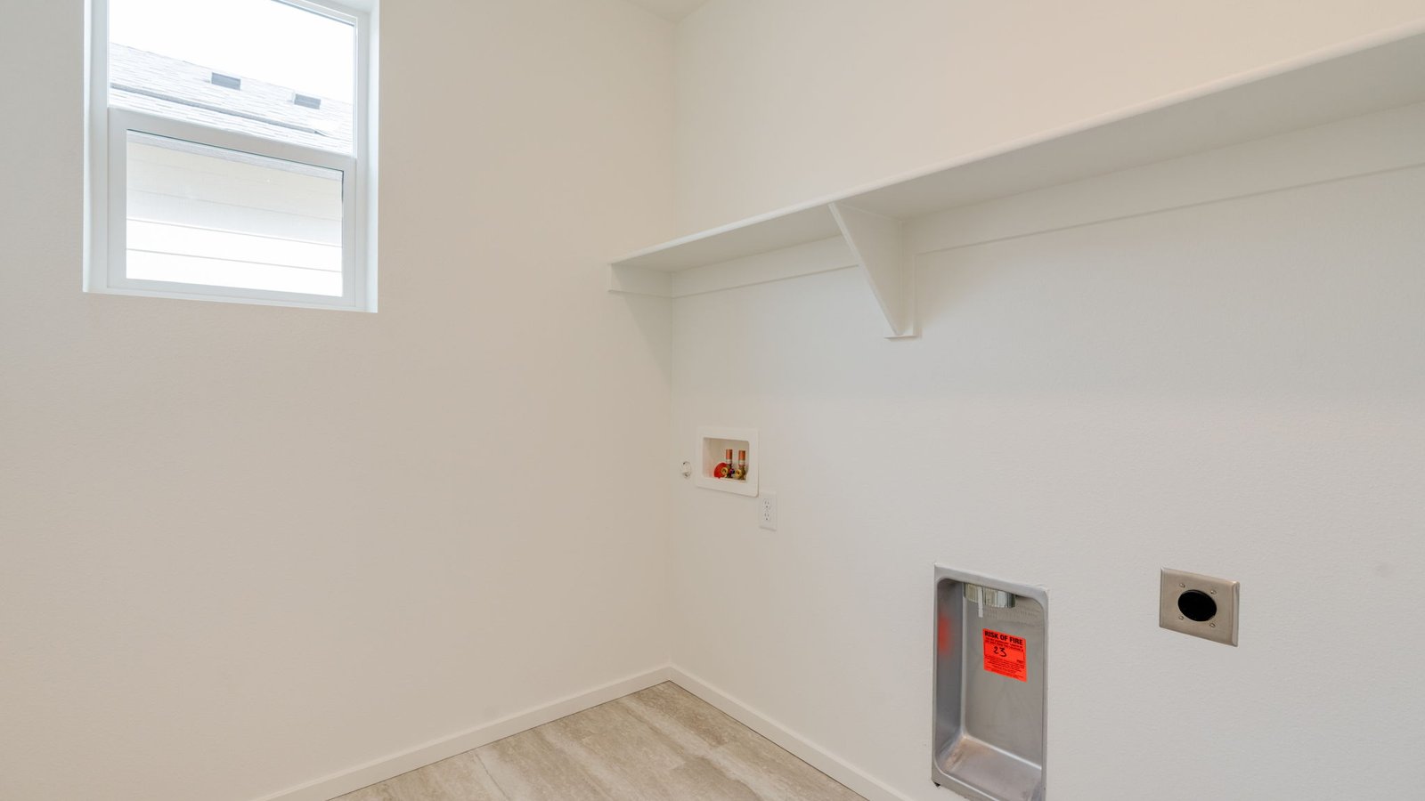 Laundry room with built-in shelves and washer and dryer hookups