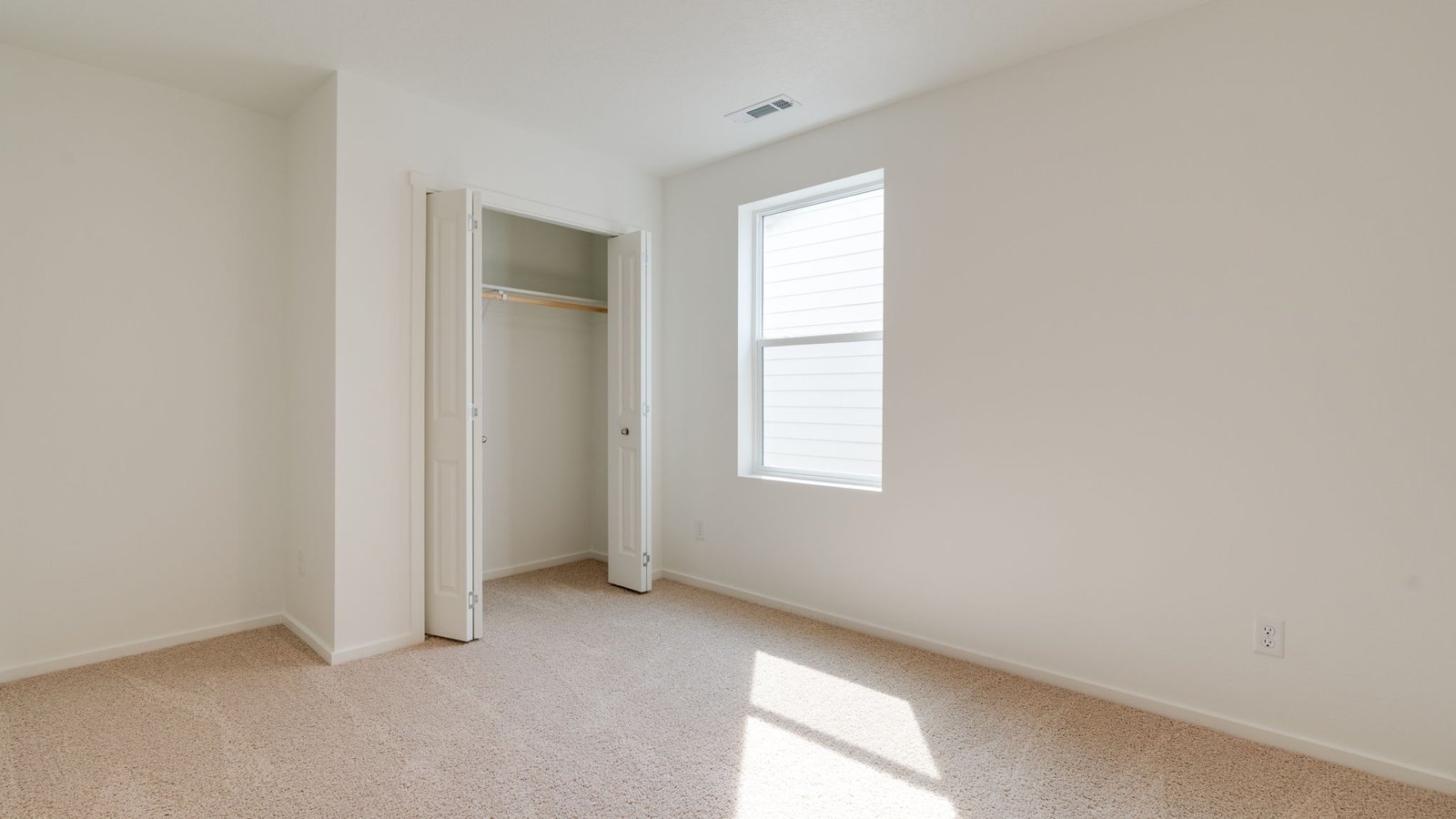 Bedroom with wall-to-wall carpet and a closet